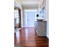 Inviting home foyer with gleaming hardwood floors, and decorative sideboard with an elegant lamp at 127 Eagles Club Dr, Stockbridge, GA 30281