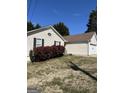 View of the home's front yard with green grass and neatly trimmed bushes at 413 Remington Ct, Villa Rica, GA 30180