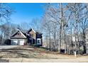 Charming two-story brick home with a well-manicured front yard and attached two-car garage, offering classic curb appeal at 6302 Manassas Nw Pass, Acworth, GA 30101