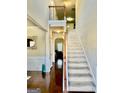 Spacious foyer featuring hardwood floors, a staircase, and elegant architectural details and high ceilings at 9444 Lantana Trail, Jonesboro, GA 30238