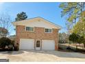 Spacious two-car garage with brick exterior, providing ample parking and storage space in a well-maintained structure at 107 Cannongate Cir, Sharpsburg, GA 30277