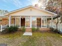 Bright sunroom with multiple glass doors, offering a seamless transition to the outdoors and abundant natural light at 107 Cannongate Cir, Sharpsburg, GA 30277