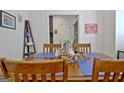 Cozy dining room with wood table set with blue mats and a view of the entryway at 747 S Fairfield Dr, Peachtree City, GA 30269