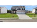 New construction home with a well-manicured lawn and a paved driveway leading to a two-car garage at 624 Kimberwick Dr, Locust Grove, GA 30248
