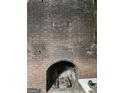 Grand brick fireplace with arched opening, ready to be the focal point of cozy gatherings at 4571 Scarborough Rd, South Fulton, GA 30349