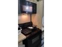 A black appliance set of a microwave and oven sit atop wooden countertops in a kitchen ready for renovation at 4571 Scarborough Rd, South Fulton, GA 30349