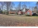 Classic brick home on a spacious lot, showcasing the property's curb appeal at 3434 Estels Ln, Conyers, GA 30013