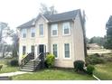 Two-story home with neutral siding, complemented by manicured landscaping, and steps leading to the front door at 3497 Thornewoode Pointe, Decatur, GA 30034
