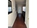 Inviting hallway with hardwood floors, leading to the living area and back door at 10467 Tara Beach Cir, Jonesboro, GA 30238