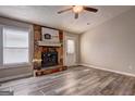 Bright living room boasts a stone fireplace, large window, and a door to the outside at 5495 Reynolds Rd, Morrow, GA 30260