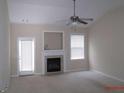 Cozy living room features a fireplace, ceiling fan, and lots of natural light at 358 Southgate Dr, Locust Grove, GA 30248