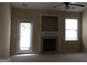 Cozy living room features a fireplace, ceiling fan, and lots of natural light at 358 Southgate Dr, Locust Grove, GA 30248