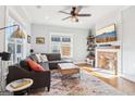 Cozy living room features a brick fireplace, hardwood floors, and large windows at 987 Lena Nw St, Atlanta, GA 30314