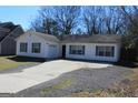 Inviting single-story home features a well-manicured lawn and a long driveway at 343 Kate Dr, Forest Park, GA 30297