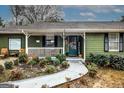 Inviting front porch with lattice trim, walkway and charming welcome sign at 888 Laney Rd, Locust Grove, GA 30248