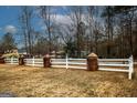 Long white fence with decorative posts lining the property's front yard at 888 Laney Rd, Locust Grove, GA 30248
