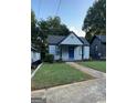 A charming one-story home with a blue front door and well-manicured lawn at 1066 Ashby Sw Grv, Atlanta, GA 30314