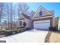 Charming home featuring stone accents, a two-car garage, and a long driveway at 168 Maple Grove Ter, Peachtree City, GA 30269