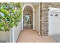Elegant front entrance with pillars and glass door, welcoming guests into a well-lit foyer at 168 Maple Grove Ter, Peachtree City, GA 30269