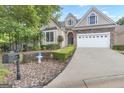 Beautiful home showcasing lush landscaping, an attached two car garage, and mailbox at street's edge at 168 Maple Grove Ter, Peachtree City, GA 30269