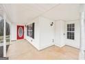Inviting covered front porch with a bright red door, offering a warm welcome to the home at 521 Cody Ln, Mcdonough, GA 30252