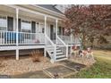 Close-up of a welcoming covered front porch with festive holiday decorations at 1144 Pickets Ridge Dr, Locust Grove, GA 30248