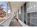 Inviting front porch with windows and cozy seating, perfect for relaxation at 1144 Pickets Ridge Dr, Locust Grove, GA 30248