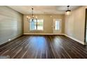 Bright dining area with hardwood floors, ship lap accent wall, modern chandelier, and large window at 2141 Bradbury Rd # 1, Moreland, GA 30259