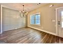 Bright dining area with hardwood floors, ship lap accent wall, modern chandelier, and large window at 2141 Bradbury Rd # 1, Moreland, GA 30259