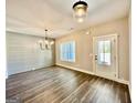 Bright dining area with hardwood floors, ship lap accent wall, modern chandelier, and large window at 2141 Bradbury Rd # 1, Moreland, GA 30259