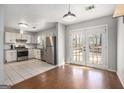 Kitchen with stainless steel appliances, white cabinets, and tile flooring at 4097 Cripple Creek Nw Dr, Kennesaw, GA 30144
