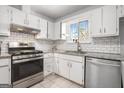 Kitchen with stainless steel appliances, granite countertops, and white subway tile backsplash at 4097 Cripple Creek Nw Dr, Kennesaw, GA 30144