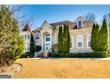 Beautiful exterior view of a two-story brick home, with manicured shrubs and a lush front lawn at 1214 Greenridge Ln, Lithonia, GA 30058