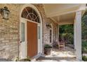 Close-up of the arched front door and cozy porch, highlighting architectural details and warm ambiance at 2275 Honeysuckle Se Ln, Smyrna, GA 30080