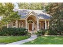 Inviting front porch with brick pillars and arched windows, offering a cozy outdoor space at 2275 Honeysuckle Se Ln, Smyrna, GA 30080