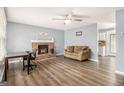 Cozy living room with a brick fireplace, ceiling fan, and lots of space for furniture at 620 Bell Se Rd, Conyers, GA 30094