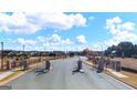View of the Gates at Pates Creek entrance with stone pillars and wrought iron gates at 615 Edgar St # 13, Hampton, GA 30228