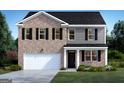 Two-story home with brick and gray shingle siding, complemented by a well-manicured green lawn at 615 Edgar St # 13, Hampton, GA 30228