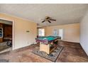 Large living room showing the billiard table with open view to the kitchen at 2864 S 100 Hwy, Bowdon, GA 30108