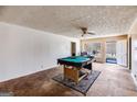 Expansive living room featuring a billiards table and natural light from large windows at 2864 S 100 Hwy, Bowdon, GA 30108