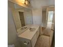 Bathroom with a vanity and a large mirror reflecting the view into an adjacent room at 419 Kara Ln, Mcdonough, GA 30253