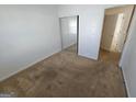 A cozy bedroom with carpet flooring and a sliding door closet for optimal storage space at 419 Kara Ln, Mcdonough, GA 30253