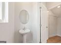 Stylish half bathroom with white fixtures and wood-look flooring at 984 Sutherland Ln # 31, Lawrenceville, GA 30043