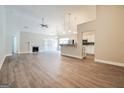 Spacious living room with hardwood floors, fireplace, and view into the bright kitchen at 1116 5Th Nw St, Atlanta, GA 30318