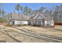 Well-maintained home featuring a lush green lawn and manicured landscaping at 209 Wynnward Way, Sharpsburg, GA 30277
