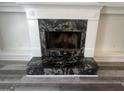 Close up view of a fireplace with a unique black and gray stone surround at 607 Tramore Ct, Stockbridge, GA 30281