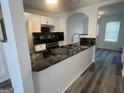 Modern kitchen featuring granite countertops, stainless steel appliances, and white cabinets at 607 Tramore Ct, Stockbridge, GA 30281