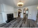 Open-concept living area with fireplace and modern flooring that leads to the kitchen at 607 Tramore Ct, Stockbridge, GA 30281