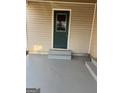 Covered entryway with newly painted concrete steps offers sheltered entry to the home at 30 Lemon Pl, Mcdonough, GA 30253