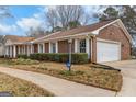 Brick home featuring an attached two-car garage and well-maintained landscaping at 210 Heritage Cir, Mcdonough, GA 30253